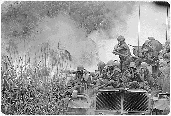 U.S. Marines riding atop a firing M-48 tank. VN April 3, 1968.